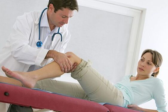 the doctor examines the legs after the operation for varicose veins. 